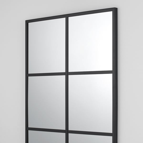 Black lindbyn mirror for wall, adds elegance to rooms.