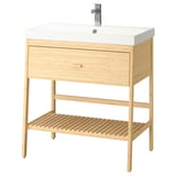 A light wooden bathroom vanity with a white sink and chrome faucet.