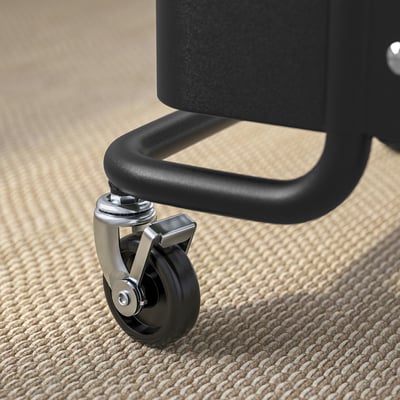 Close-up of a black chairs caster wheel - sturdy, metallic, with a central swivel joint.