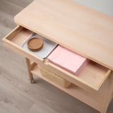 Light wooden trolley with drawer open, revealing storage boxes and a round woven coaster. Suitable for kitchen or dining area organization.
