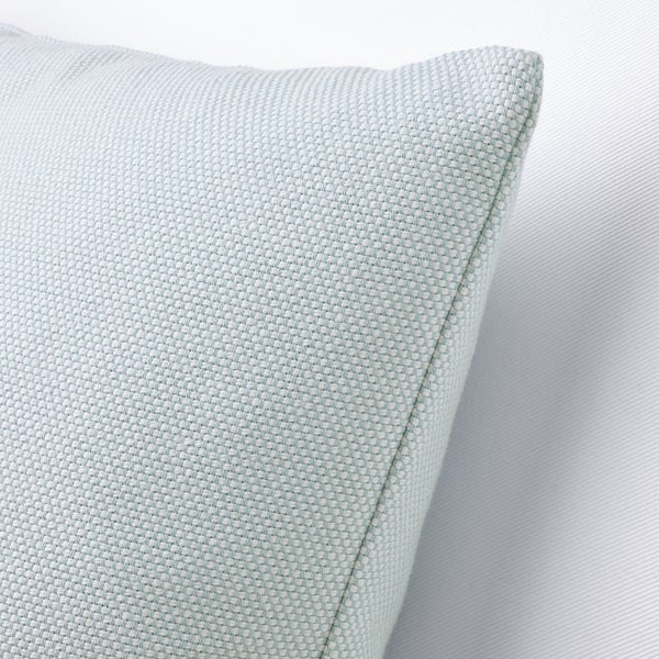 Pillow cover with tightly woven light blue and white cotton, showcasing a textured, tactile surface. Zipper access for washing.