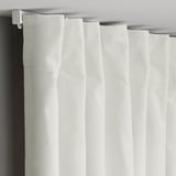 Velvet curtains hang elegantly, filtering light and providing privacy.