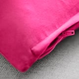 Bright pink cushion cover with zipper, smooth cotton velvet texture.