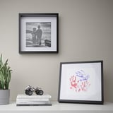 Wall: family photo, art print, books, toy, plant. Frame has shadow effect.