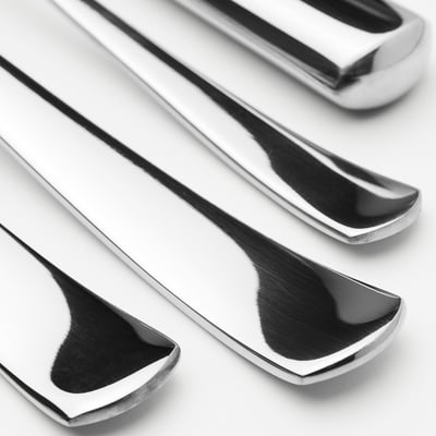 Polished silver cutlery set, clean modern design; includes fork, knife, large spoon, smaller spoon, all stainless steel.