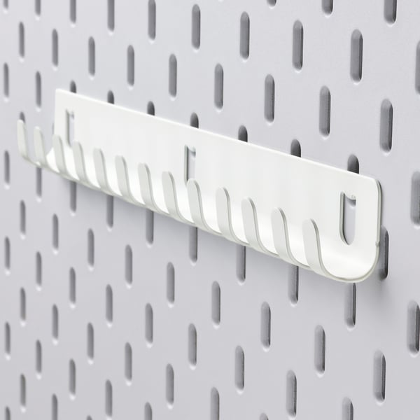 White metal pegboard with multi-hook organizer.