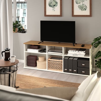 SKRUVBY tv bench in oak with tv, books, and storage.