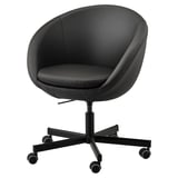 Black IKEA SKRUVSTA office chair, round with high back, padded seat, adjustable height, swivel base, and casters.