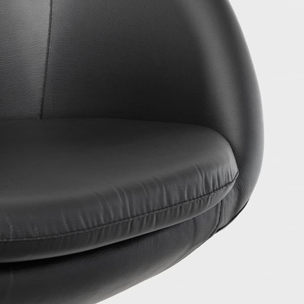 Close-up of a modern black office chair, showcasing its padded seat and backrest with smooth, high-quality fabric.