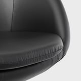 Close-up of a modern black office chair, showcasing its padded seat and backrest with smooth, high-quality fabric.