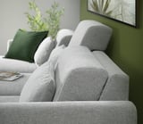 Modern living room with gray SLATORP sectional sofa, dark green pillows, and flat-screen tv. Plant on the side table.