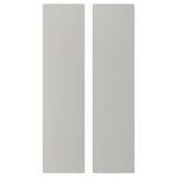 Two tall, rectangular, grey, pastel-colored doors made of fibreboard.