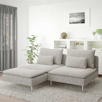 Modern minimalist living room: light grey SÖDERHAMN sectionals, large cushions, speckled rug, potted plant, curtained window, wall picture.