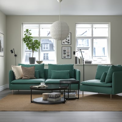 Modern living room with green SÖDERHAMN sectional, round tables, large pendant light, two windows.