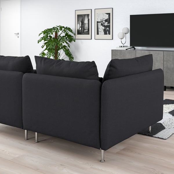 Modern black l-shaped SÖDERHAMN sofa on wooden floor, near tv, rug, and plant.