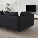 Modern black l-shaped SÖDERHAMN sofa in living room, stylish and comfortable with wooden floor and tv setup.