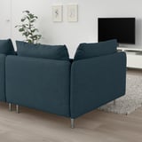 Modern living room with large, blue SÖDERHAMN sectional sofa, large cushions, and metal legs. Flat screen tv and greenery nearby.