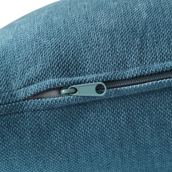 Close-up of high-quality zipper on soft, textured blueish-gray fabric, likely from a corner sofa section.