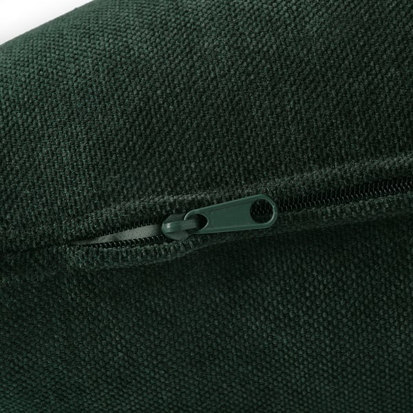 Close-up of dark green zipper on durable, textured fabric, likely from a sofa.