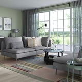 Modern living room with gray SÖDERHAMN sectional sofa, striped rug, and large windows.