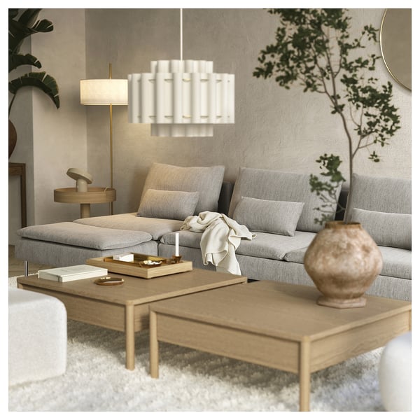 Modern living room featuring a grey SÖDERHAMN sofa with a sleek design and wooden coffee table. A stylish white pendant light hangs above.