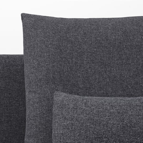 Close-up of dark grey fabric sofa, showcasing smooth texture and clean stitching.