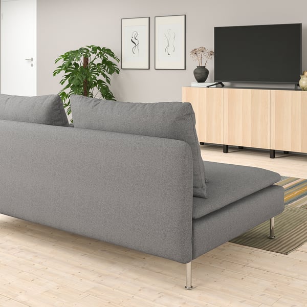 Modern living room with gray SÖDERHAMN sofa, large tv, wooden floor, and plant. Sofa is spacious with low lines.