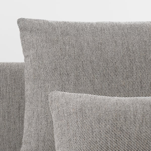 Grey tweed fabric sofa close-up; soft, elegant texture, clean lines.