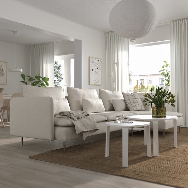 Modern living room with SÖDERHAMN sectional, foam cushions, two coffee tables, minimalist design, and greenery.