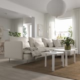 Modern living room with SÖDERHAMN sectional, foam cushions, two coffee tables, minimalist design, and greenery.