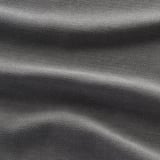 Close-up of sleek, textured upholstery, showcasing skills quality. Deep, relaxed seating style.