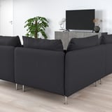 Modern living room with l-shaped SÖDERHAMN sofa in black fabric, tv, and plant. Comfortable and minimalist.