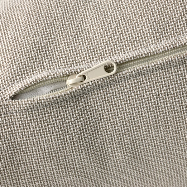 Close-up of a high-quality zipper on a woven, textured fabric, likely from a sofa or cushion cover.