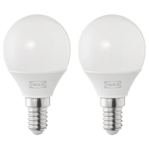 Two ikea led light bulbs, round and white, made of plastic.