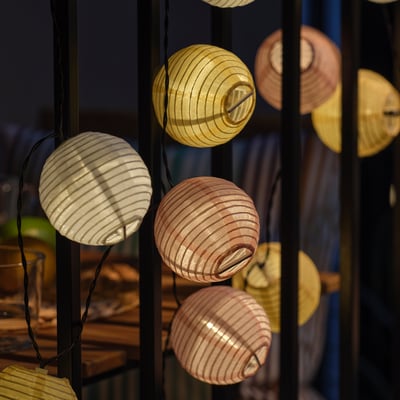 SOLVINDEN solar-powered lanterns, multicolored spheres on strings, eco-friendly, brighten outdoor spaces.
