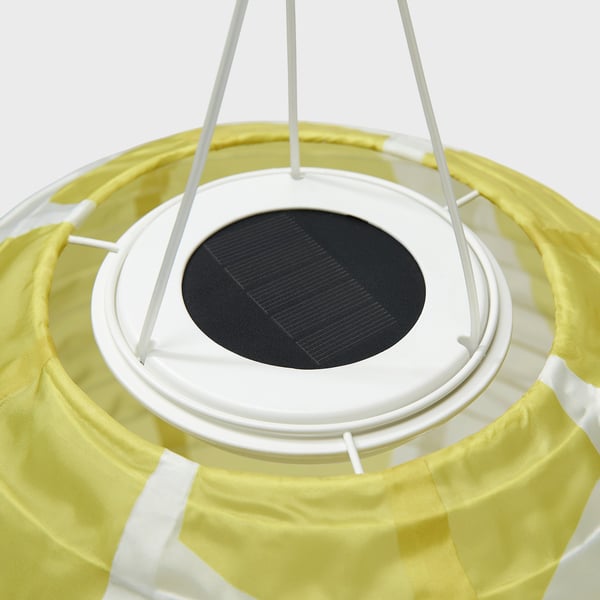 Solar-powered lamp with yellow fabric shade, central black solar panel, and white supporting frame. Eco-friendly design for outdoor use.