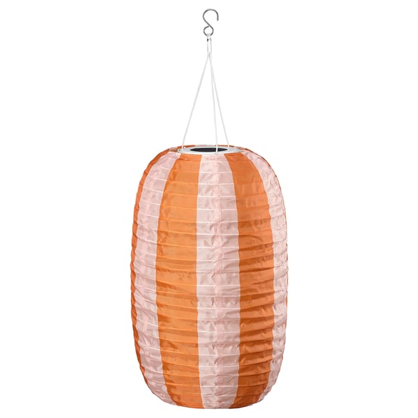 A SOLVINDEN solar lantern in orange and white stripes. Its round, made from recycled pet bottles, and hangs from a hook.
