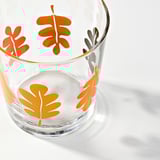 Glass tumbler with vibrant orange leaves, hand-painted. Clear, high quality glass, perfect for autumn.