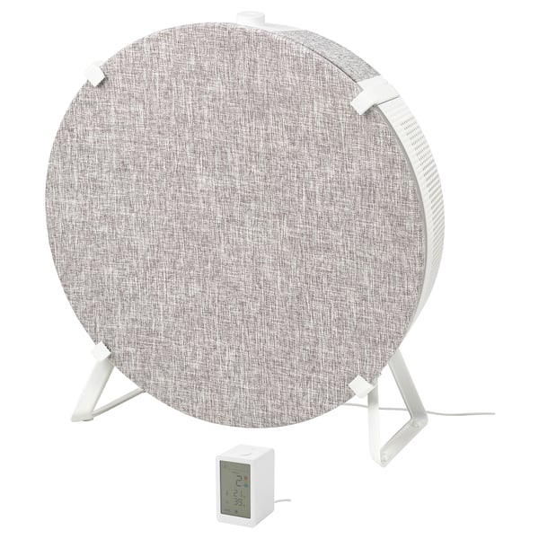 A STARKVIND air purifier in white and gray. Its circular with a fabric cover, standing on three legs, and includes a control panel.