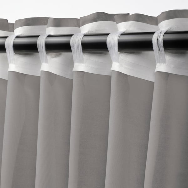 Curtain rod with sheer, grey STENFRÖ curtains, pleated with white heading tape, diffusing daylight.
