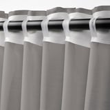 Curtain rod with sheer, grey STENFRÖ curtains, pleated with white heading tape, diffusing daylight.