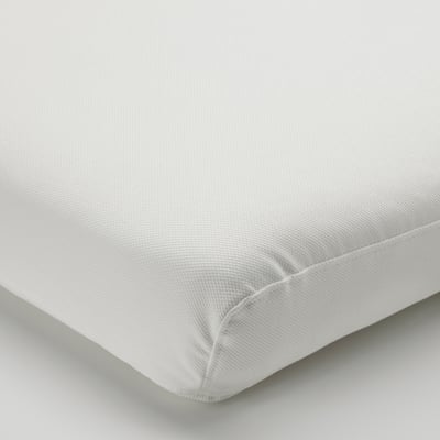 White cushion with neat stitching and smooth fabric.