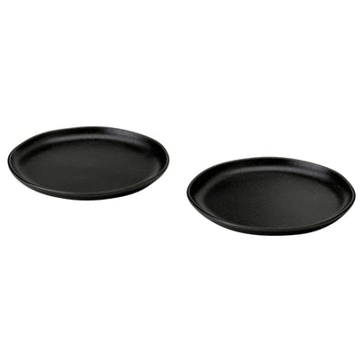 Two black, round, rustic-style side plates with irregular, textured surfaces and matte finish.