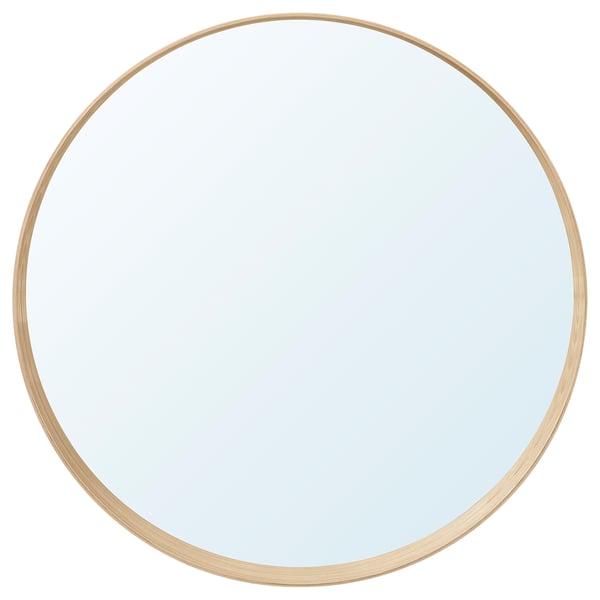 A round mirror named STOCKHOLM with an ash veneer frame. It has a unique design with a bottom shelf for accessories.