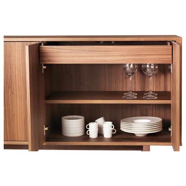 Walnut sideboard with adjustable shelves, white tableware, push-open doors.
