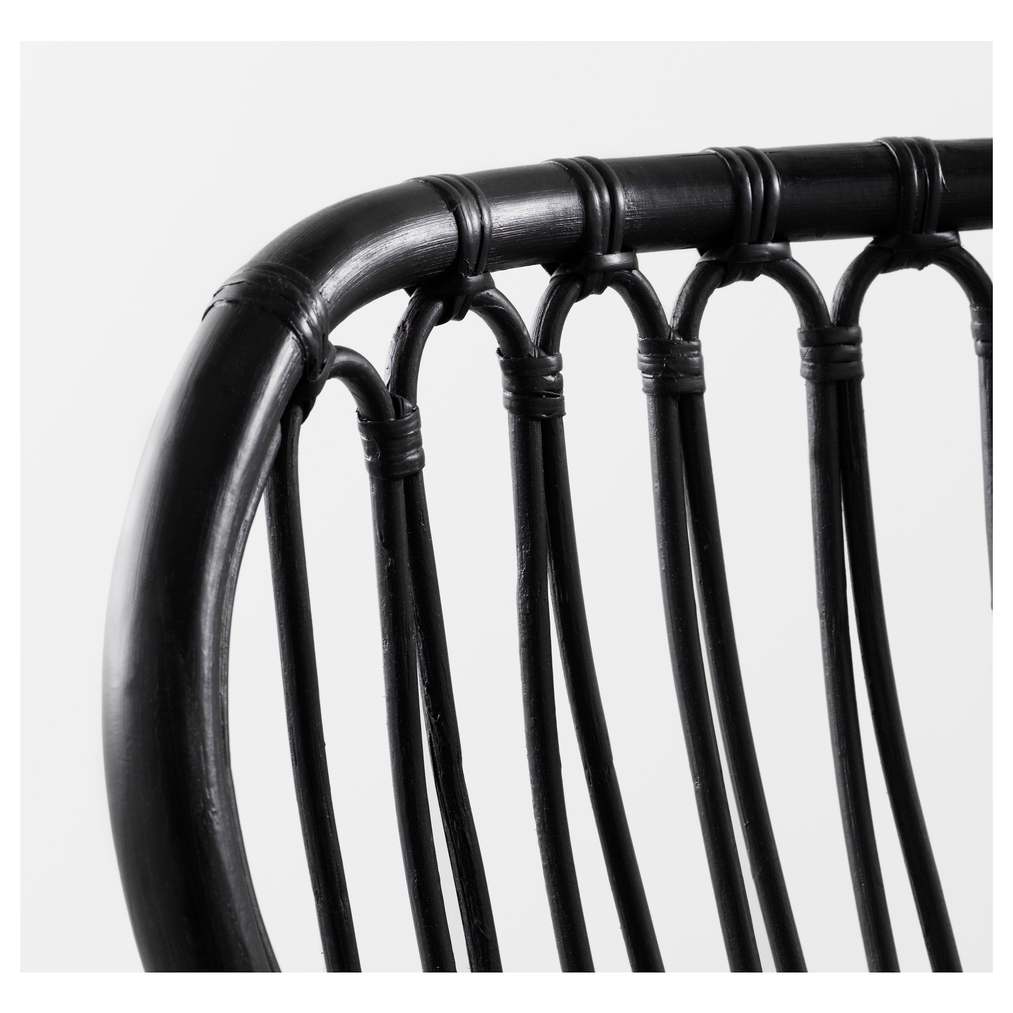 Black woven rattan chair back, expertly crafted, showcasing intricate patterns and sturdy design.