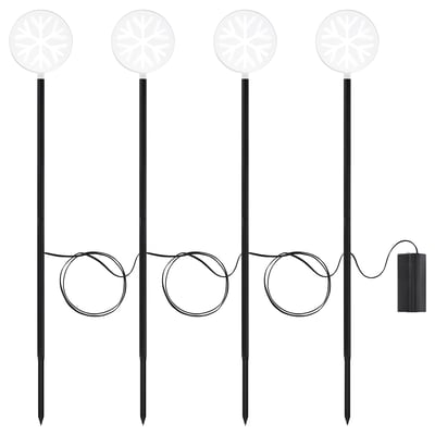 Four white snowflake-shaped garden lights on black poles, powered by a connected battery box, for outdoor decorative use.