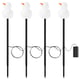 Four white snowman-shaped led lights on black sticks, with orange noses, powered by a battery box, perfect for outdoor christmas decoration.
