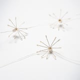 Three delicate golden wire stars hang, creating a festive mood.