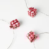 Three checkered gift boxes with glowing wires and led lights.